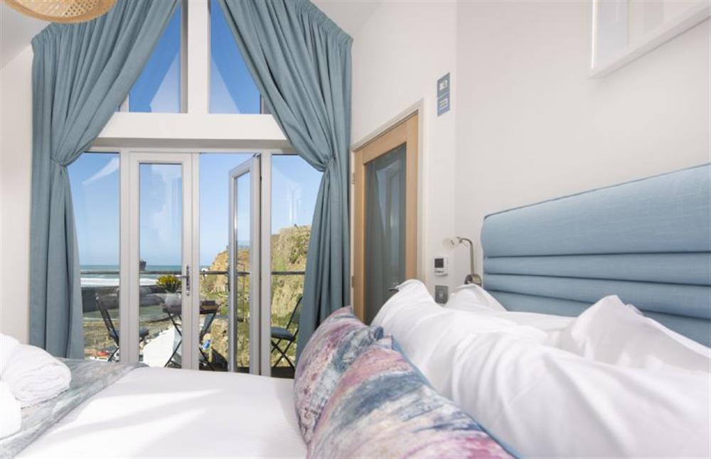 Master bedroom with second balcony with views out to sea at Harbour Masters House, Portreath
