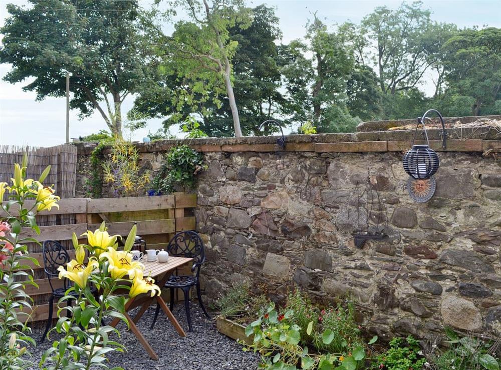 Enclosed courtyard with garden furniture at Harbour Retreat in Garlieston, Wigtownshire