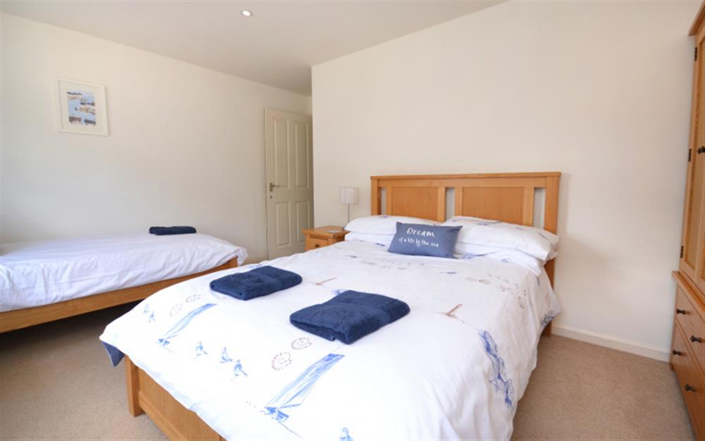 Bedroom 1 with double bed and single bed at Harbour View Apartment in Salcombe