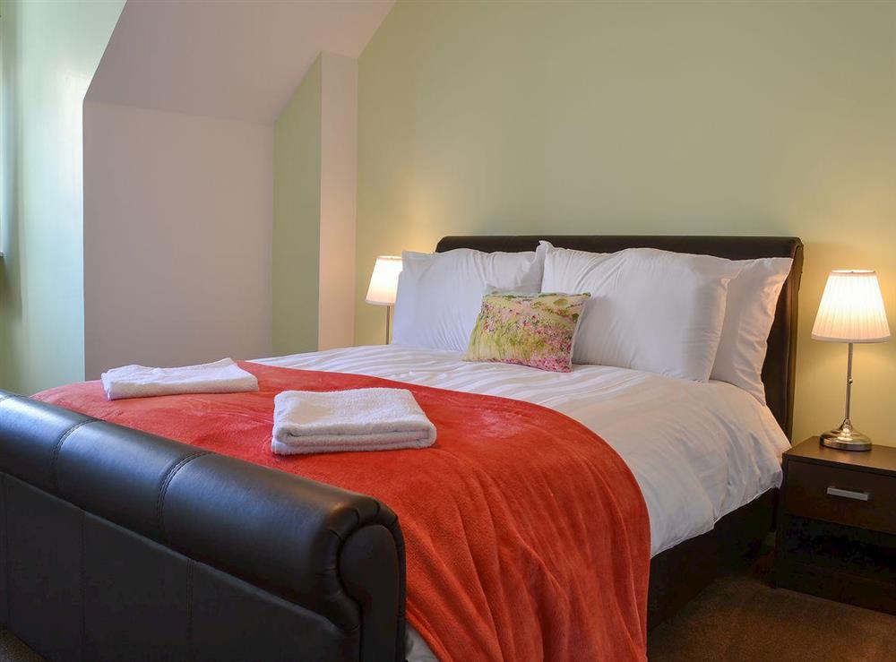 Double bedroom with leather bed at Harbour View in Oban, Argyll and Bute, Scotland