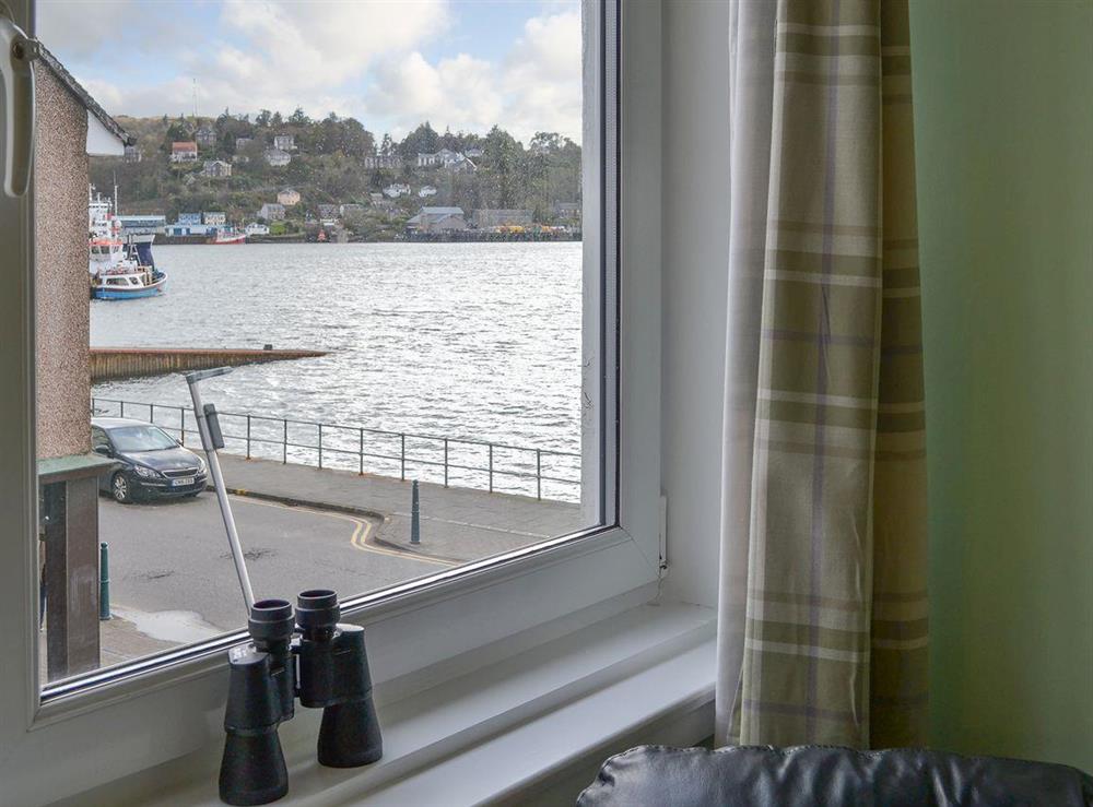 See the bustling Oban harbour from the living room window at Harbour View in Oban, Argyll and Bute, Scotland