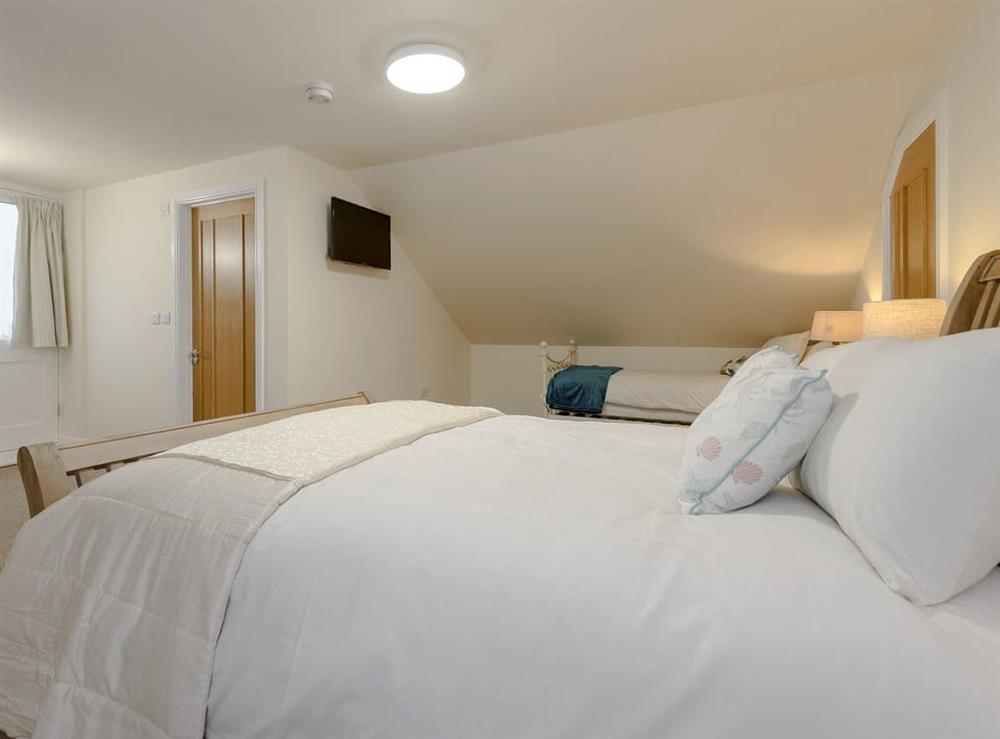 Comfortable bedroom with kingsize bed and single bed at Harbour View in Wainfleet St. Mary, near Skegness, Lincolnshire