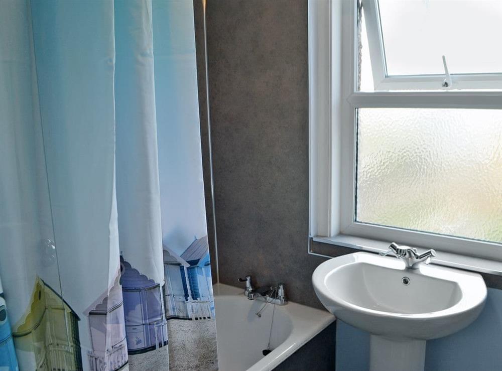 Bathroom with shower over small bath at Harbour Walk in Amble, near Warkworth, Northumberland