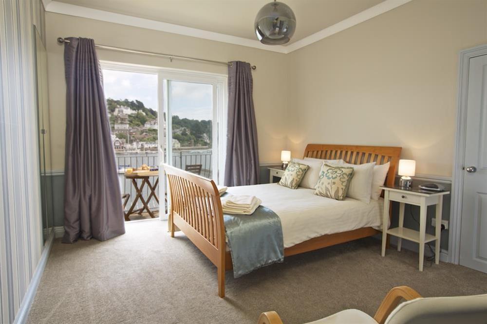 Master bedroom with a balcony and views towards Kingswear at Harbourside in South Town, Dartmouth