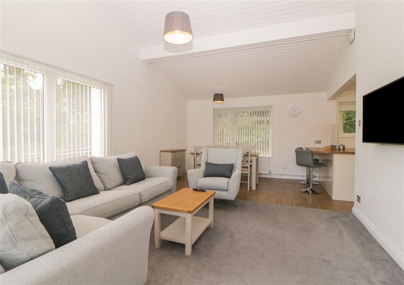 Relax in the living area at Harcombe House Bungalow 1, Chudleigh