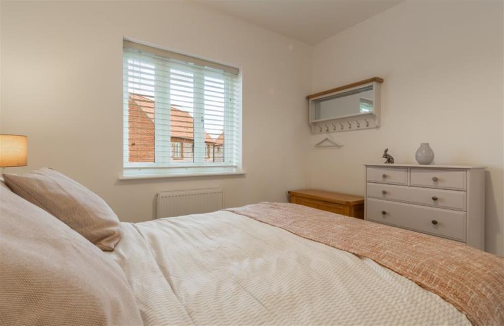 First floor: Bedroom two has plenty of storage and a peg rail with mirror at Hare Cottage, Bodham near Holt