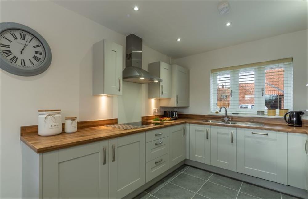 Ground floor: The modern kitchen has painted units with wooden worktops at Hare Cottage, Bodham near Holt