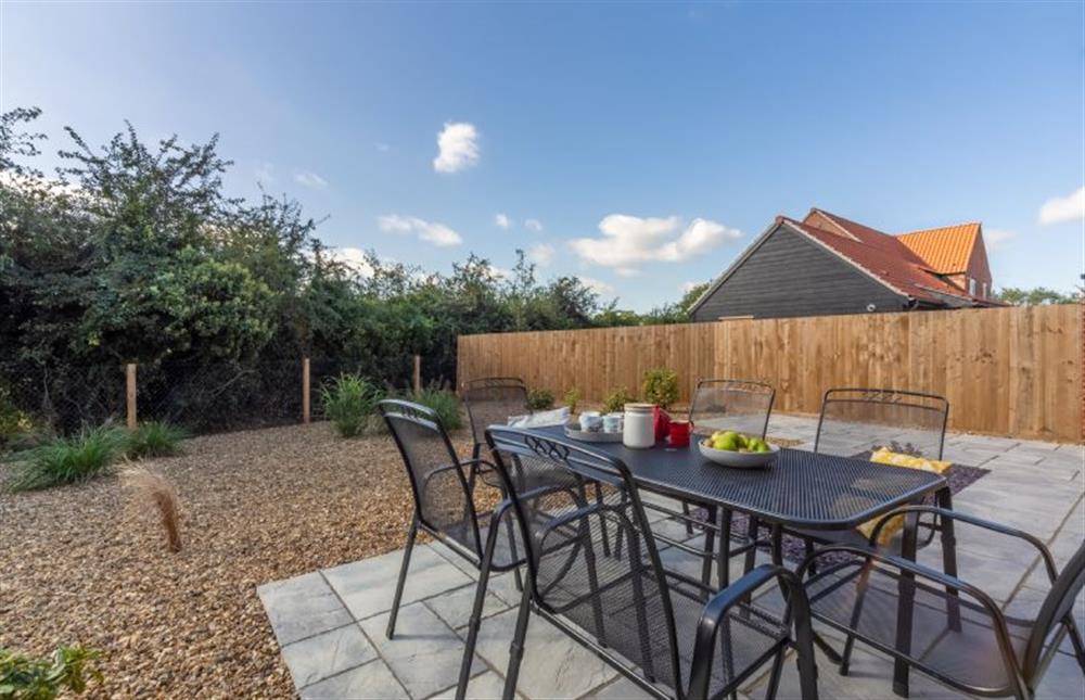 The rear garden is practical and sunny and comes with garden furniture and a barbecue at Hare Cottage, Bodham near Holt