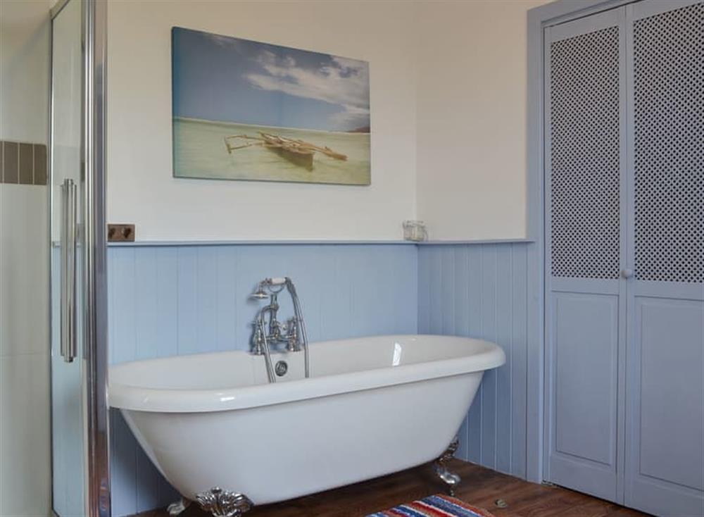 Bathroom with roll-top bath and separate shower at Harebeck Cottage in Gosforth, near Whitehaven, Cumbria