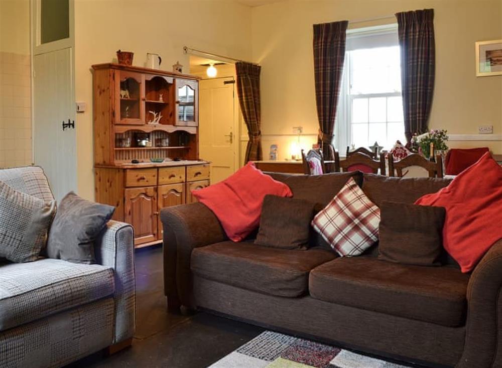 Living room with dining area at Harebeck Cottage in Gosforth, near Whitehaven, Cumbria