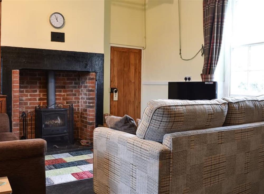 Living room with wood burner at Harebeck Cottage in Gosforth, near Whitehaven, Cumbria