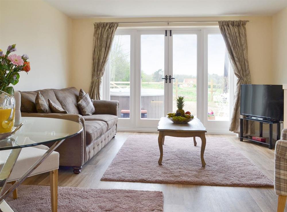 Stylish living area with French doors to patio at Hares Home in Thursford, near Fakenham, Norfolk