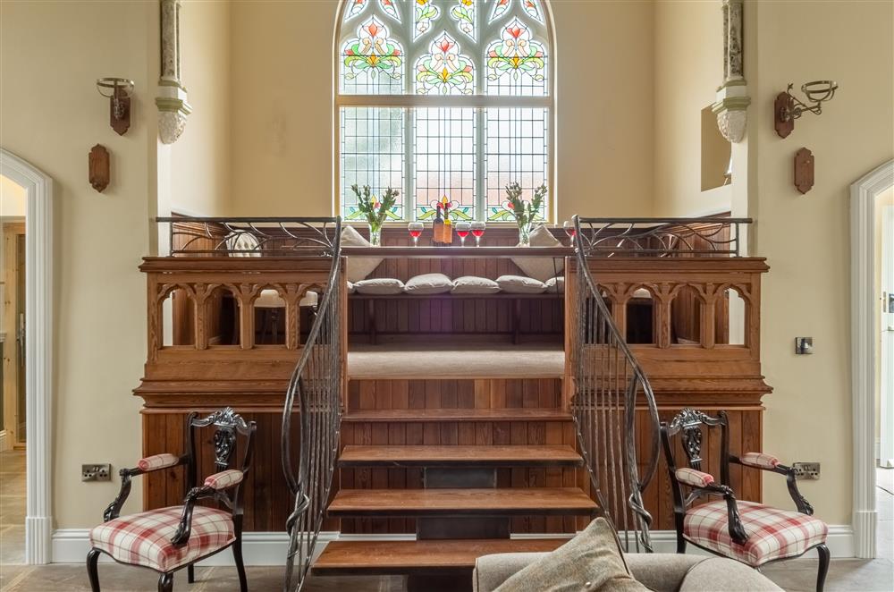 Ground floor: Steps up to the original pulpit with seating area at Harome Chapel, Harome, near Helmsley 