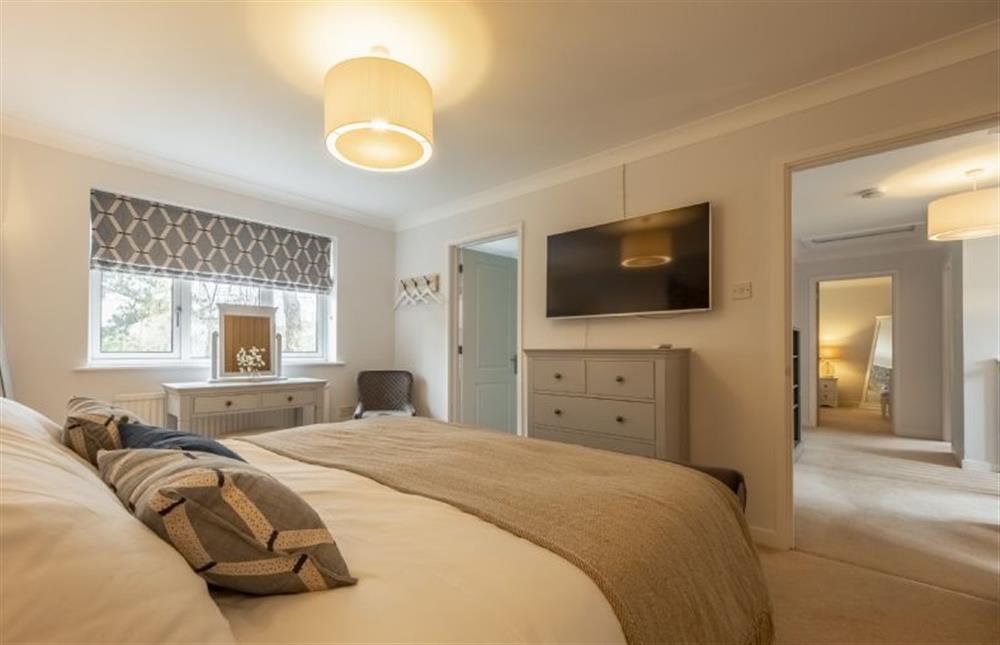 First floor: Master bedroom with wall mounted television at Harp Garden, Fakenham