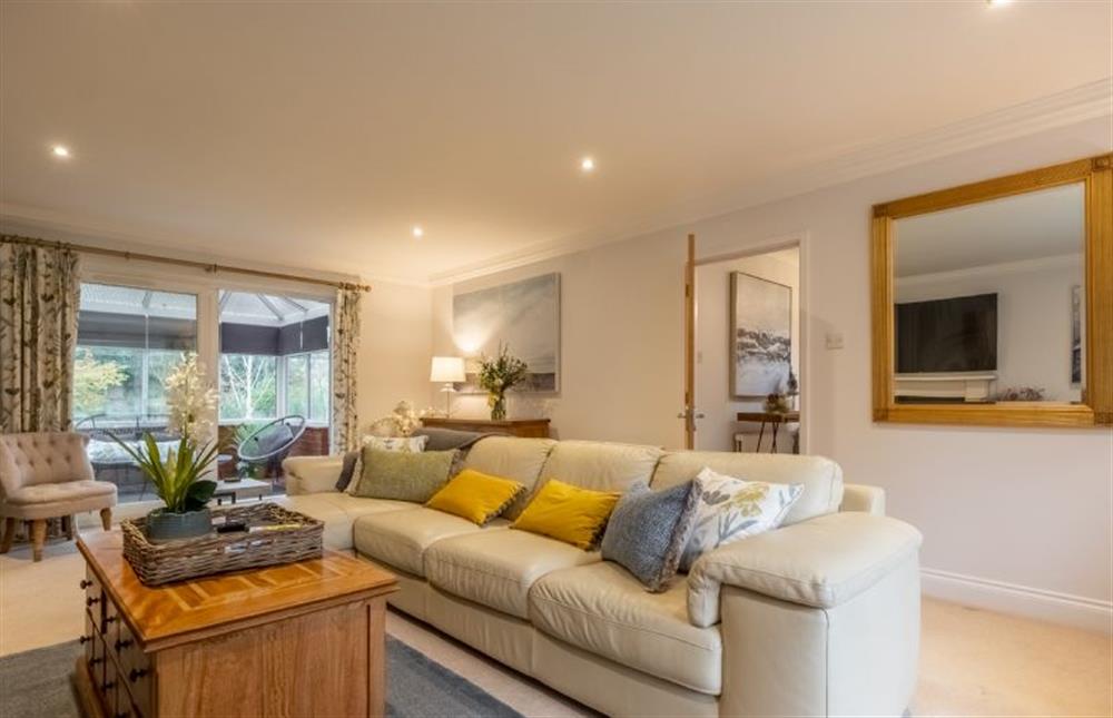 Ground floor: An attractive sitting room with cream leather sofa at Harp Garden, Fakenham