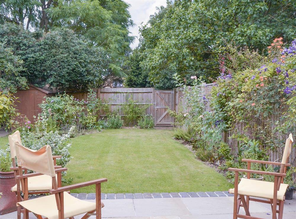 Attractive enclosed garden with patio at Harrison Barber Cottage in Colnbrook, near Windsor, Berkshire
