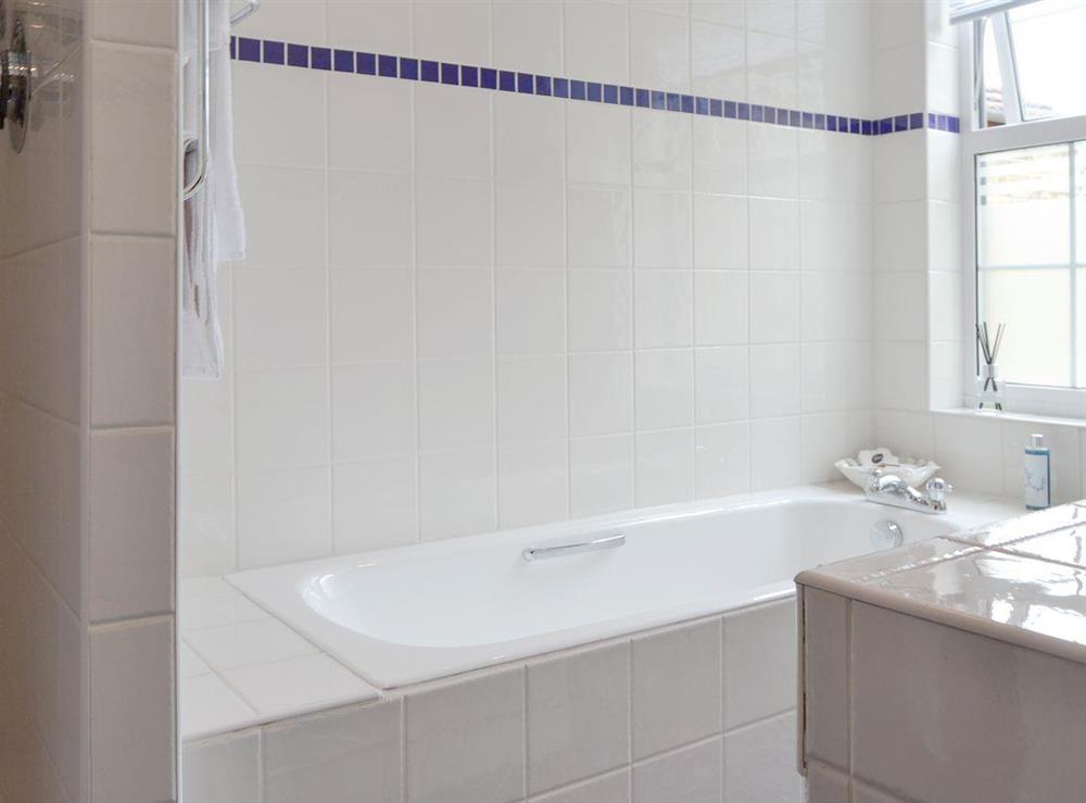 Family bathroom with bath and separate walk-in shower at Harrison Barber Cottage in Colnbrook, near Windsor, Berkshire