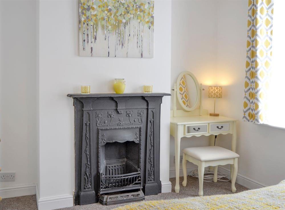 Feature fireplace within double bedroom at Harrison Barber Cottage in Colnbrook, near Windsor, Berkshire