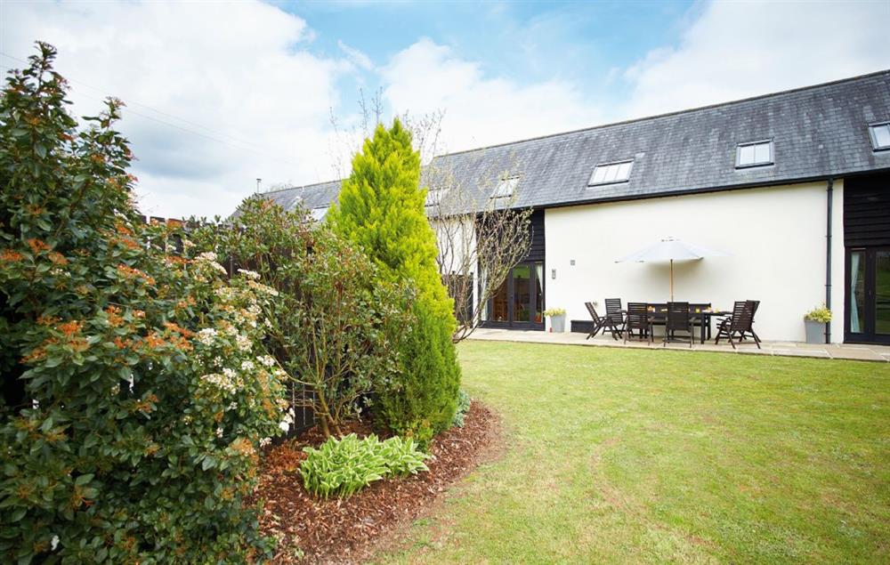 Large fully enclosed garden with terrace and dog-proof fencing at Harvest Moon, Feniton