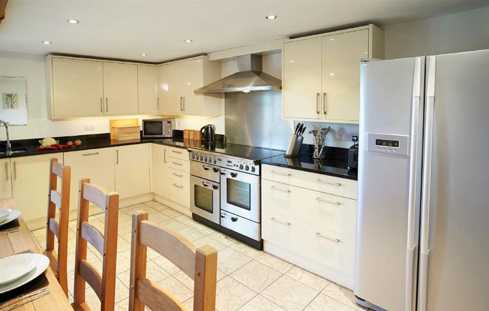 Large kitchen/dining/family room, with French doors to terrace and garden. Dining table can be extended to seat 12