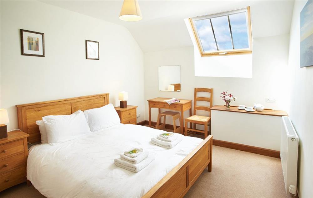 Master bedroom with 5’ bed, en-suite bathroom with shower over bath at Harvest Moon, Feniton