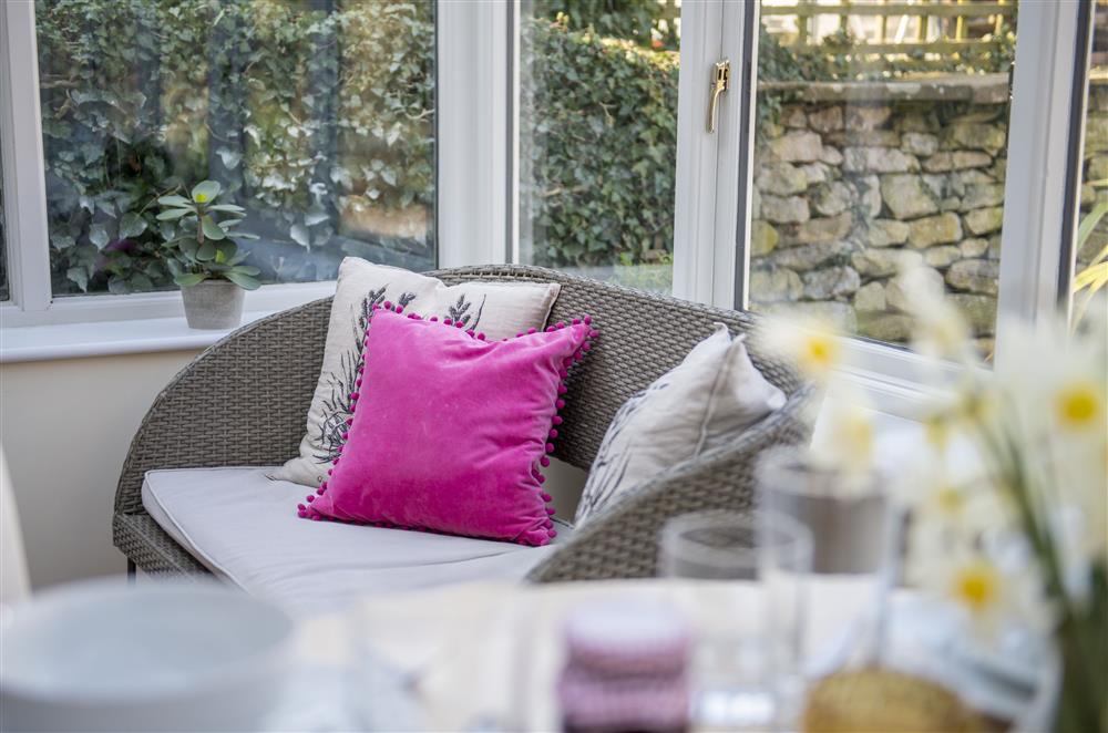 Comfy seating in the conservatory at Harwood Cottage, Hovingham