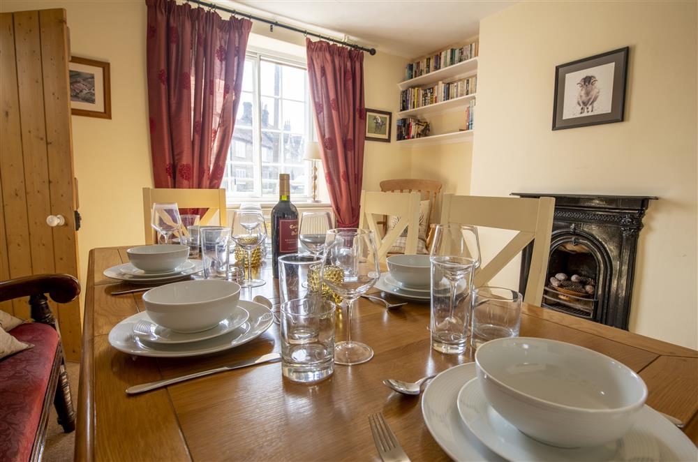 Elegant dining room with feature fireplace (not in use) at Harwood Cottage, Hovingham