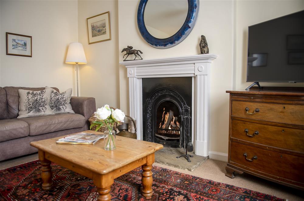 Sitting room with open fire at Harwood Cottage, Hovingham