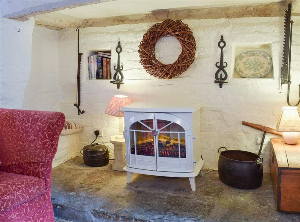 Relax in the cosy living room by the electric wood burner at Hathaway Hamlet in Stratford-upon-Avon, Warks., Warwickshire