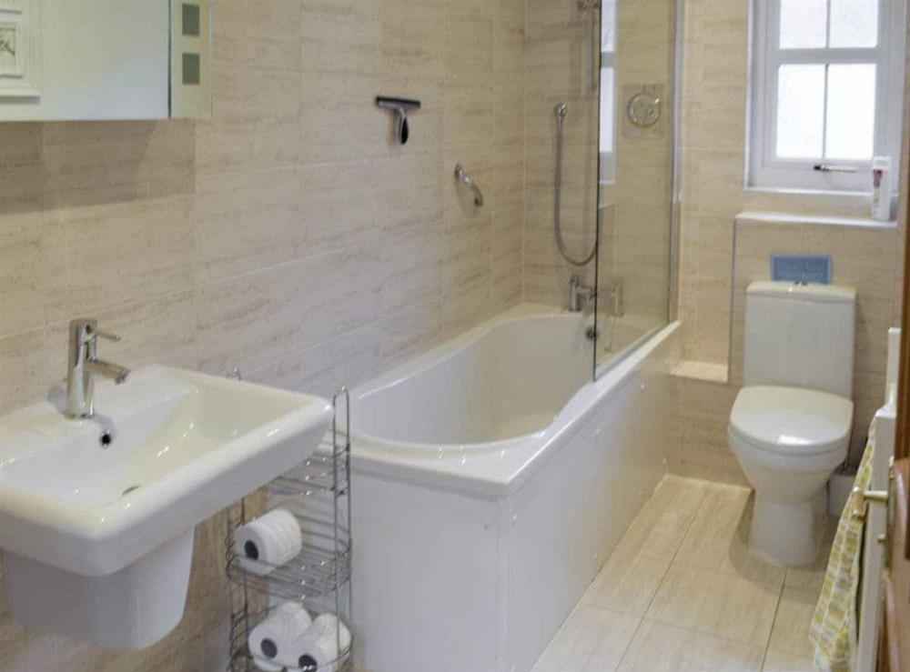 Family bathroom with shower over bath at Heather Croft, 