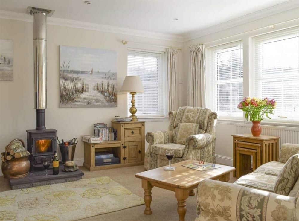 Welcoming living room with wood burner at Heather Croft, 