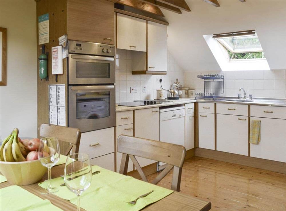 Well-equipped kitchen with dining area at Osprey Cottage, 