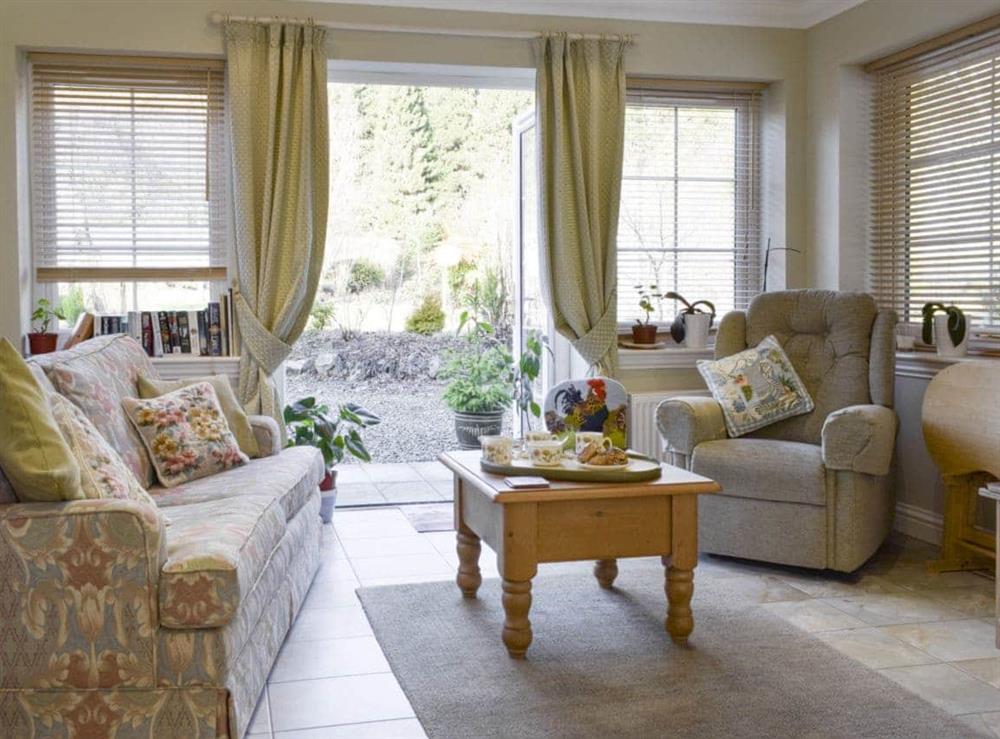 Welcoming living room with French doors to garden at The But ‘n Ben, 