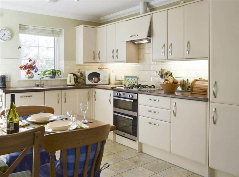 Well-equipped fitted kitchen with dining area at The But ‘n Ben, 