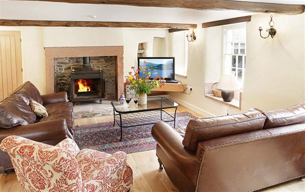Open plan sitting room with wood burning stove