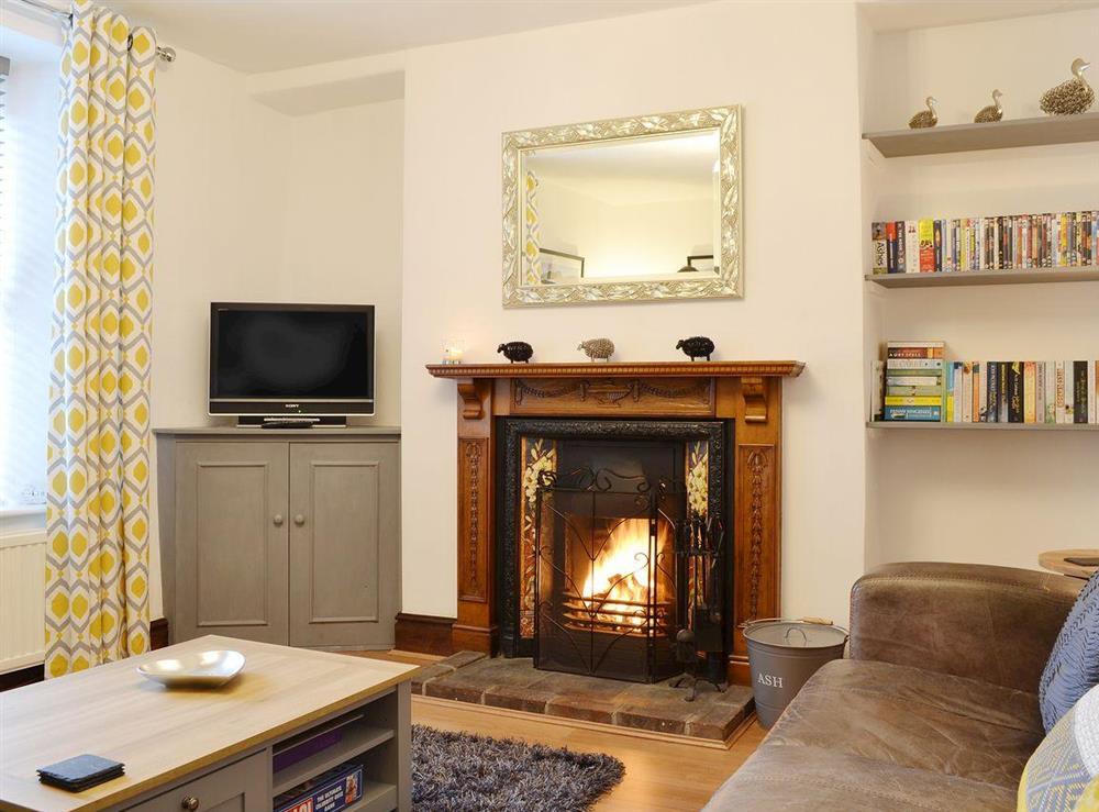 Open fireplace in comfortable living room at Havelock Cottage in Windermere, Cumbria