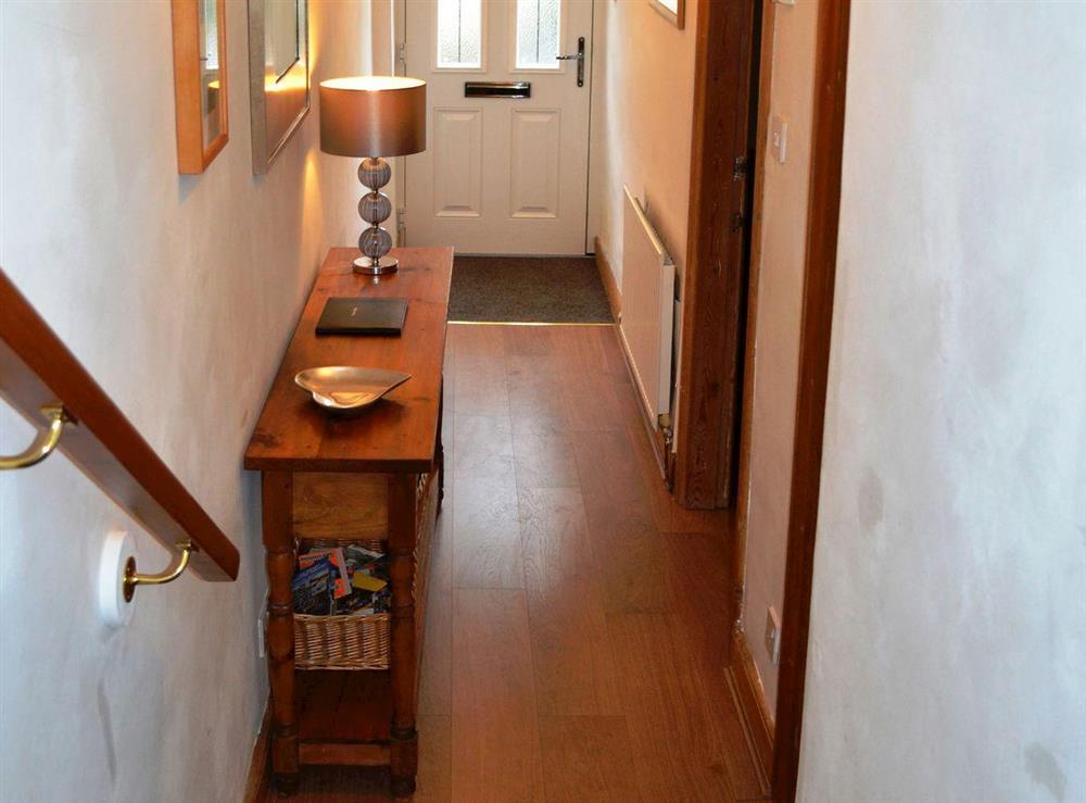 View down the stairs to the hallway at Havelock Cottage in Windermere, Cumbria