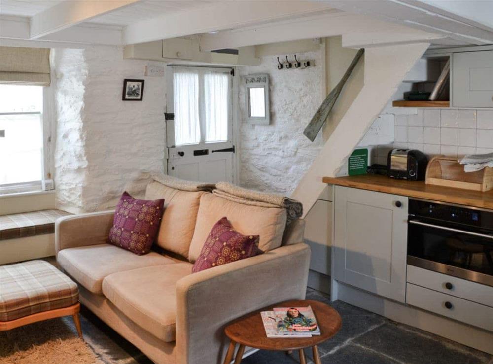 Open plan living space with slate floor & wood beams at Haven Cottage in Port Isaac, Cornwall