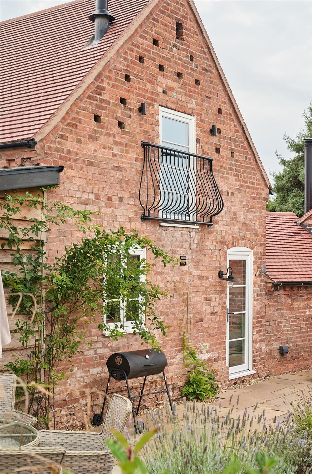 The exterior of the cottage with a Juliet balcony