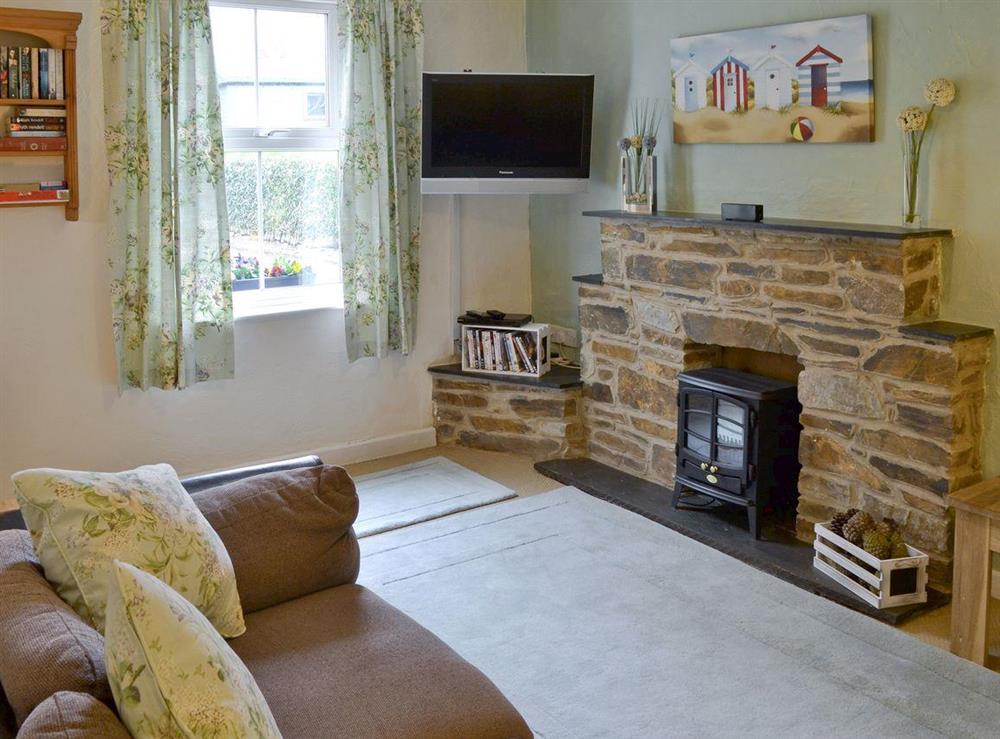 Cosy lounge with stone feature fireplace at Hay Cottage in St Austell, S. Cornwall., Great Britain