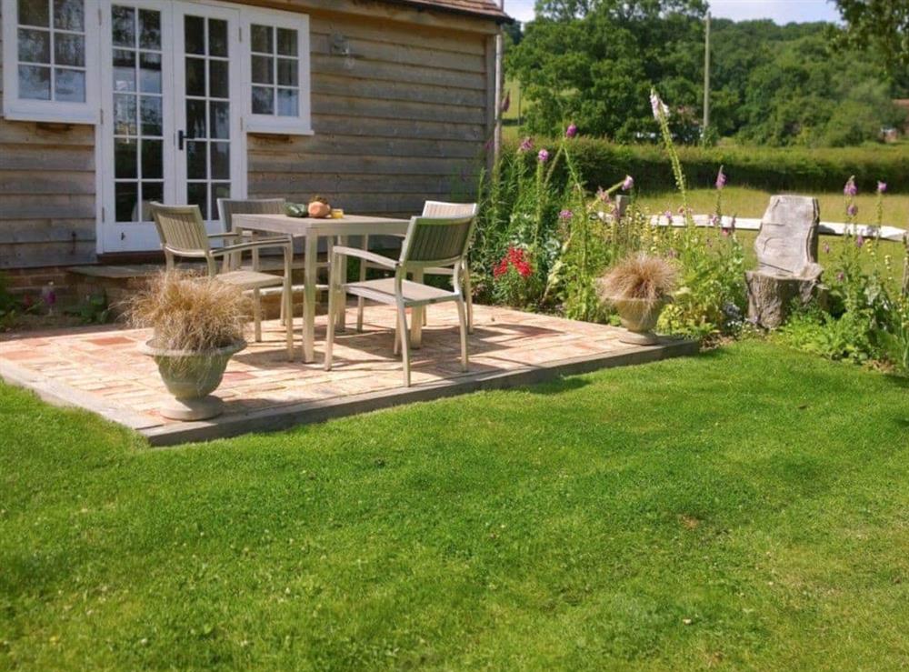 Paved patio area within garden at Hayesland Lodge in Beckley, near Rye, East Sussex
