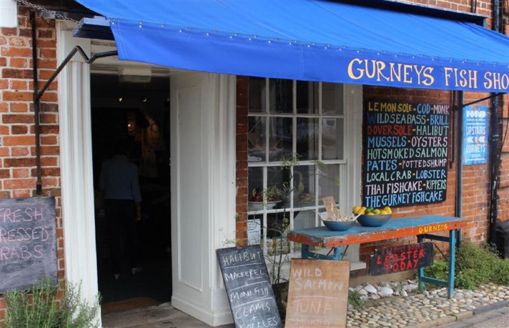 Busy some of the freshest fish for supper from Gurneys fish shop at Hayloft, Burnham Market near Kings Lynn