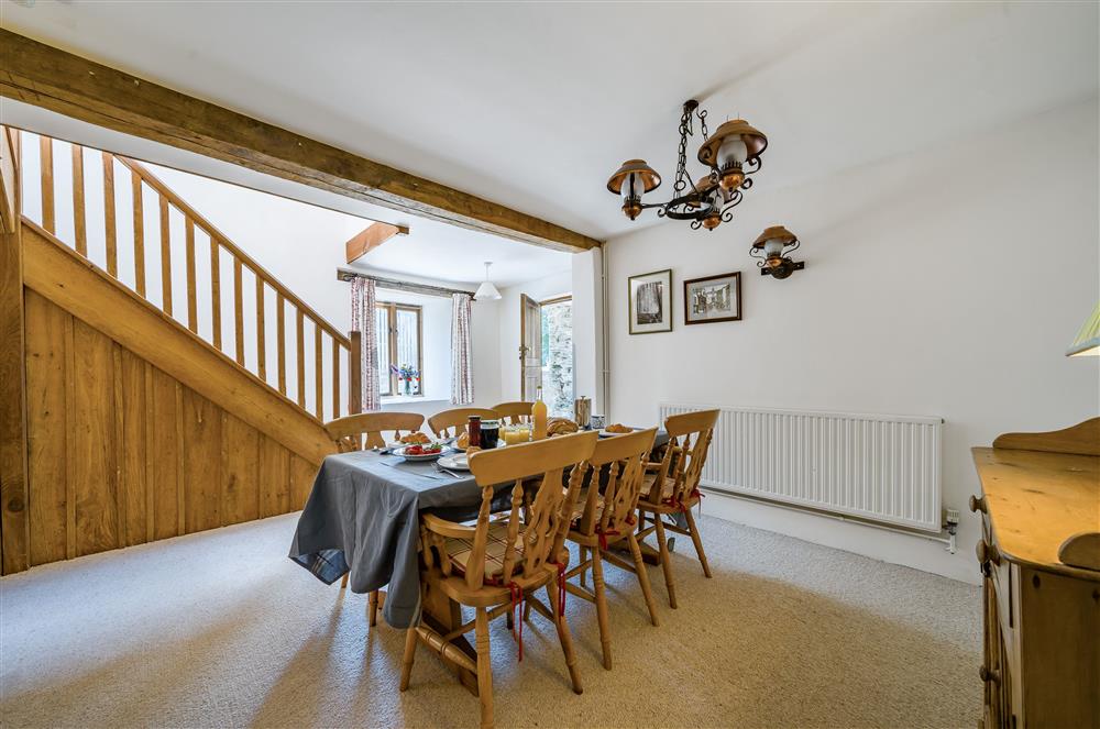 The dining room with table seating six guests at Hayloft Cottage, Totnes