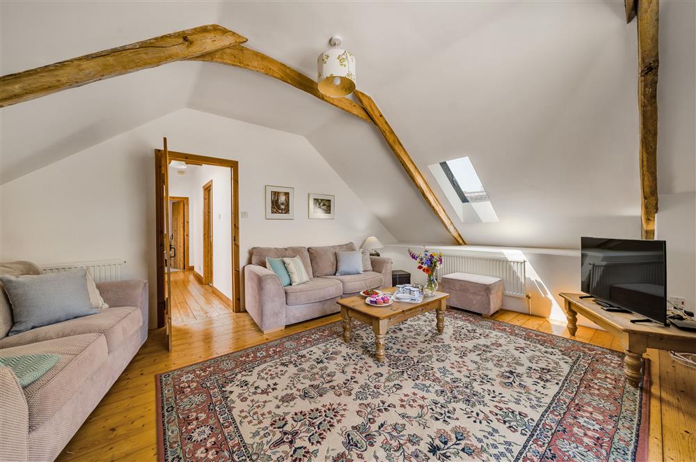 The sitting room with its characterful beams and plenty of space at Hayloft Cottage, Totnes