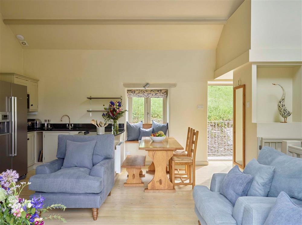 The open-plan sitting, dining and kitchen area at Haytor Cottage, Dartmouth