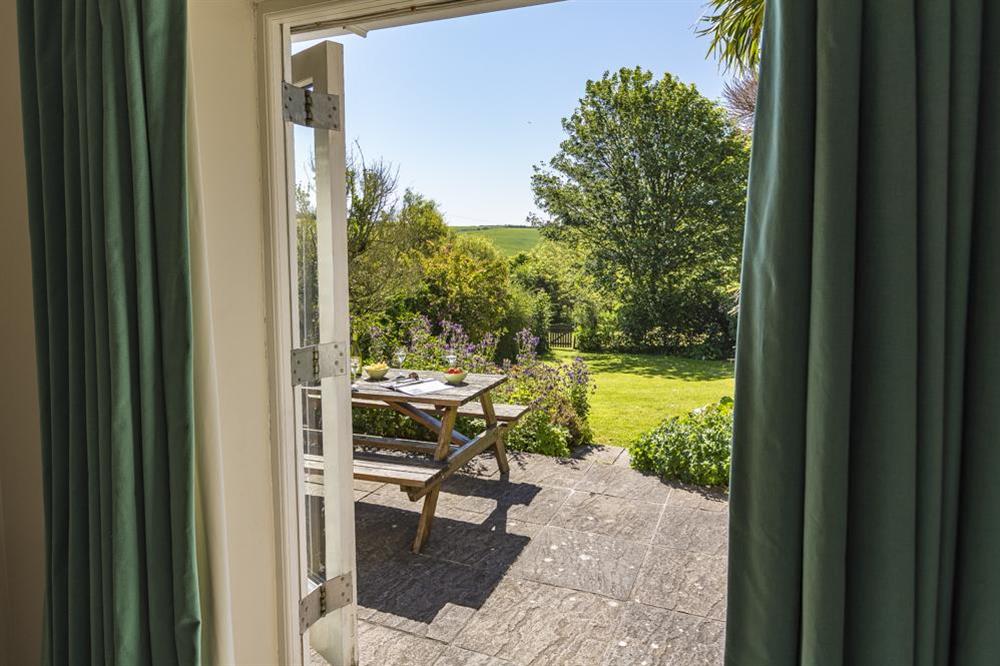 Doors lead out to a terrace and garden at Hazel Cottage in Malborough, Nr Salcombe