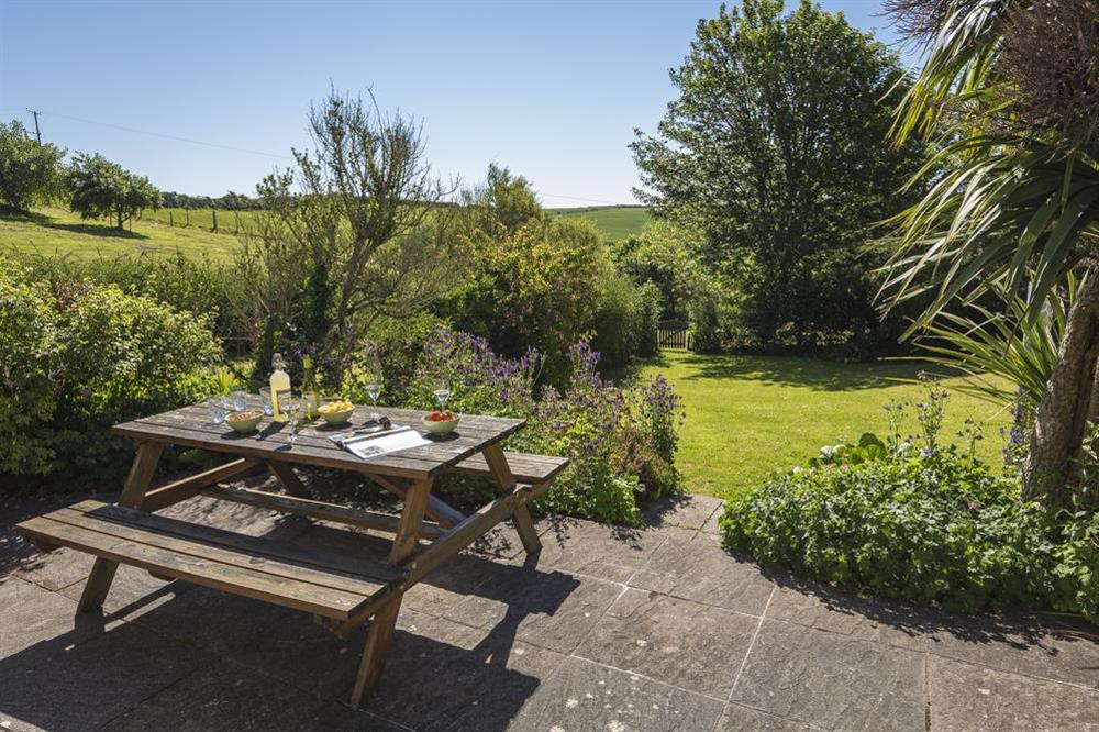 Large terrace with picnic table and built-in barbeque at Hazel Cottage in Malborough, Nr Salcombe