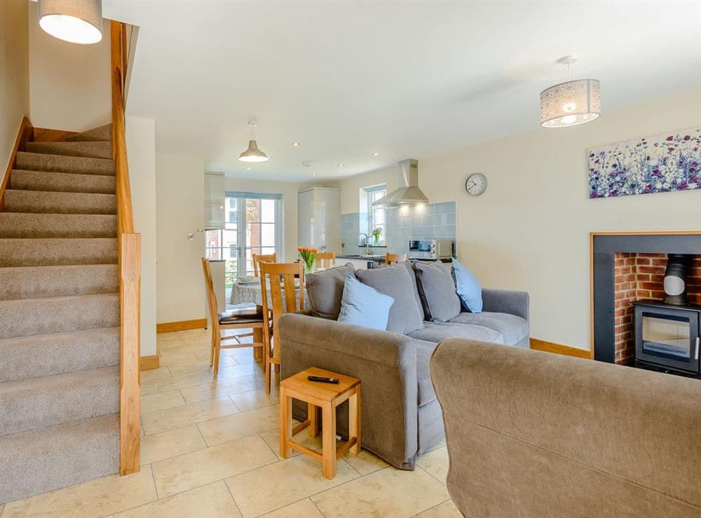 Lovingly furnished open plan living space at Buttercup Cottage, 