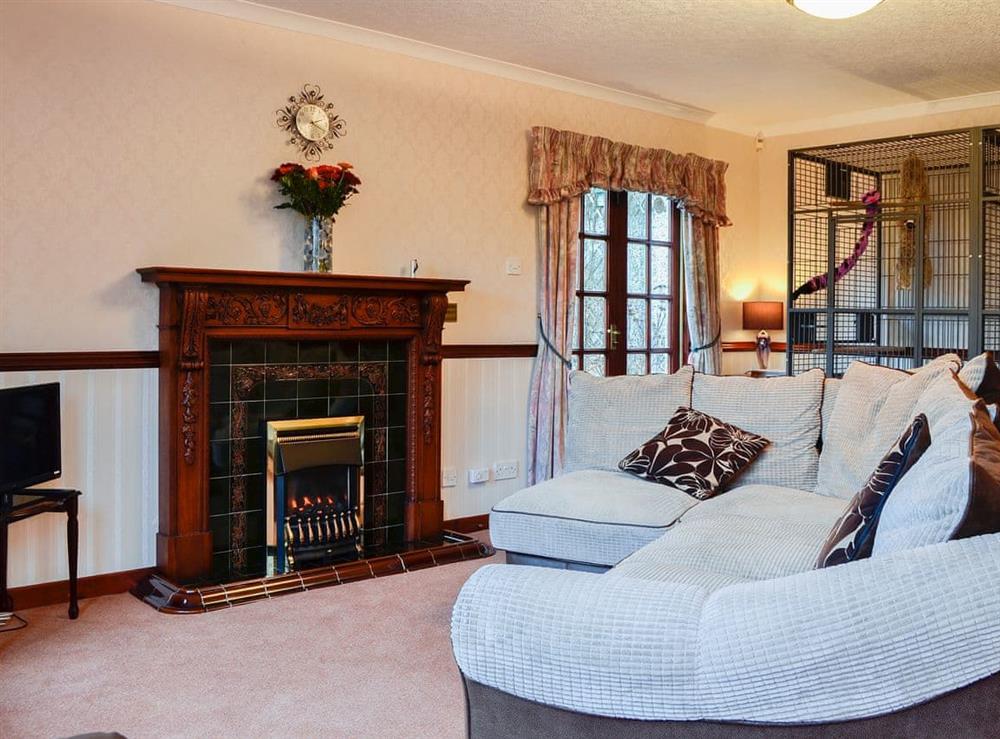 Spacious living area with imposing fireplace at Hazelmere in Rattray, near Blairgowrie, Perthshire