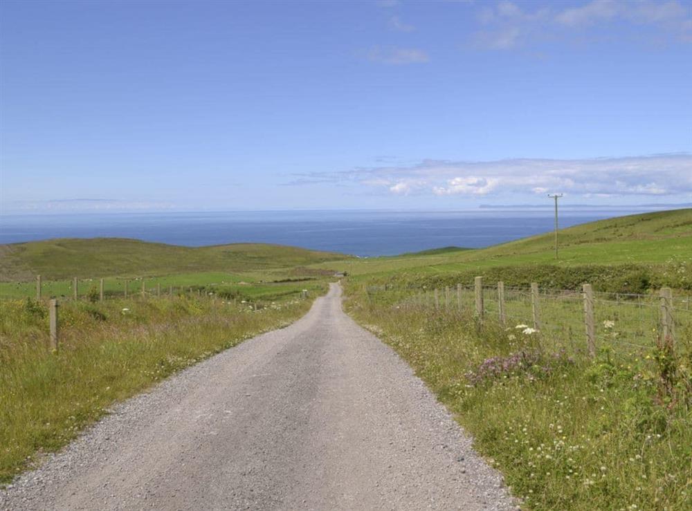 Gravelled lane leading towards the shore at Hazels Cottage in Tangy, near Campbeltown, Argyll and Bute, Scotland